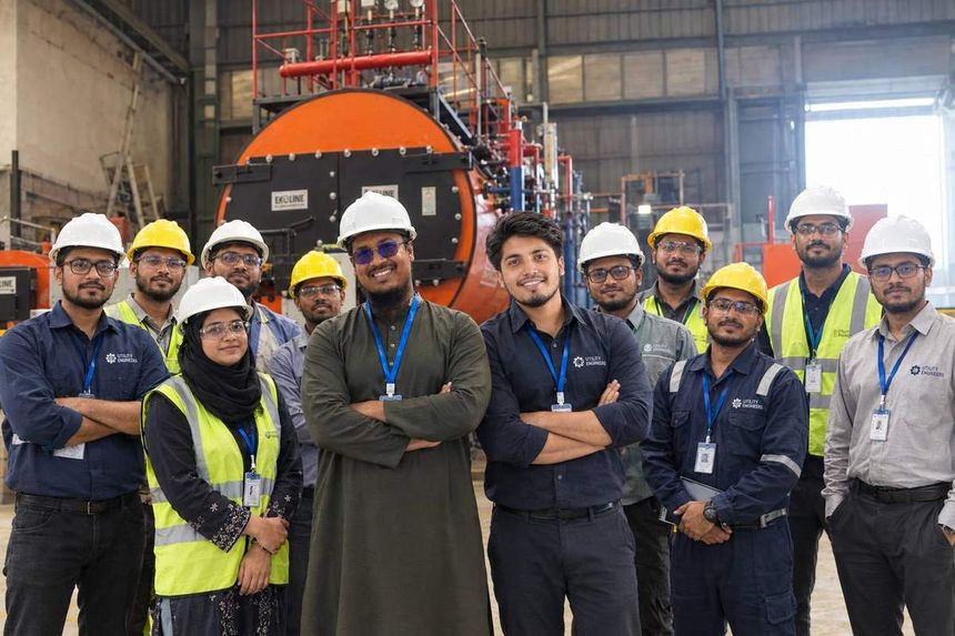 The Utility Engineers team in front of a boiler